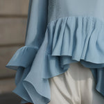 Elegant Sky Blue Peplum Blouse With Tiered Ruffle Hem And Flared Sleeves