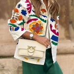 White denim overshirt embroidered with bright colors and pockets