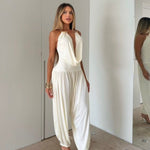 Gioia dress. Timeless elegance encapsulated in a fluid and sensual silhouette. This draped jumpsuit is designed for the woman who knows how to effortlessly command attention.