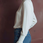 Elegant High Neck White Blouse With Smocked Cuffs And Ruffle Details