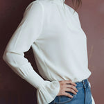 Elegant High Neck White Blouse With Smocked Cuffs And Ruffle Details