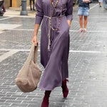 Satin shirt dress with a fitted waist and side slit.