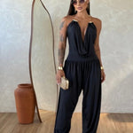 Gioia dress. Timeless elegance encapsulated in a fluid and sensual silhouette. This draped jumpsuit is designed for the woman who knows how to effortlessly command attention.