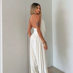 Gioia dress. Timeless elegance encapsulated in a fluid and sensual silhouette. This draped jumpsuit is designed for the woman who knows how to effortlessly command attention.