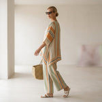 Elisabetta – elegant asymmetric top with wide-leg trousers