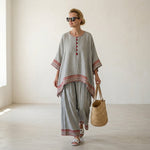 Rossella – Refined asymmetric blouse with wide-leg ethnic trousers