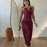 Gioia dress. Timeless elegance encapsulated in a fluid and sensual silhouette. This draped jumpsuit is designed for the woman who knows how to effortlessly command attention.
