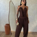 Gioia dress. Timeless elegance encapsulated in a fluid and sensual silhouette. This draped jumpsuit is designed for the woman who knows how to effortlessly command attention.