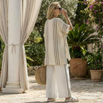 Raffaella – Elegant ivory linen blouse paired with black striped trousers