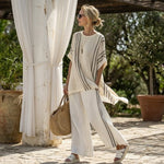 Raffaella – Elegant ivory linen blouse paired with black striped trousers