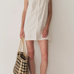 Short Skirt with Pearl Buttons and Scalloped Trim and Round Neck.