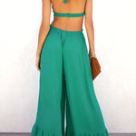 Solid color halter neck open back flared jumpsuit