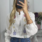 White shirt with colorful embroidered flowers
